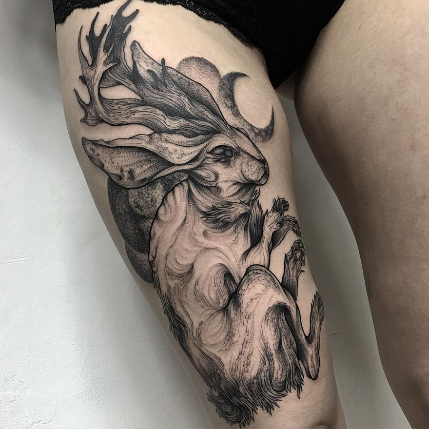 Dark and eerie creature tattoo by Russian artist on thigh, depicting a mythical horned animal.