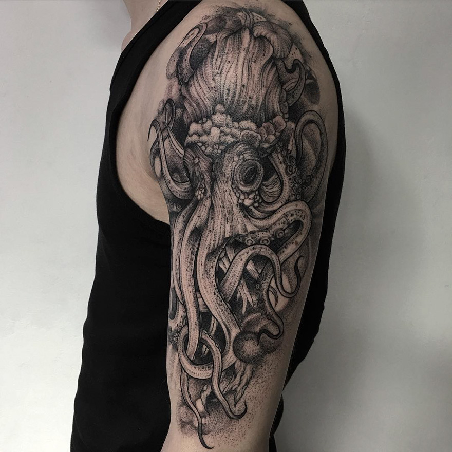 Eerie creature tattoo of an octopus by Russian artist on the upper arm, showcasing intricate detail and shading.