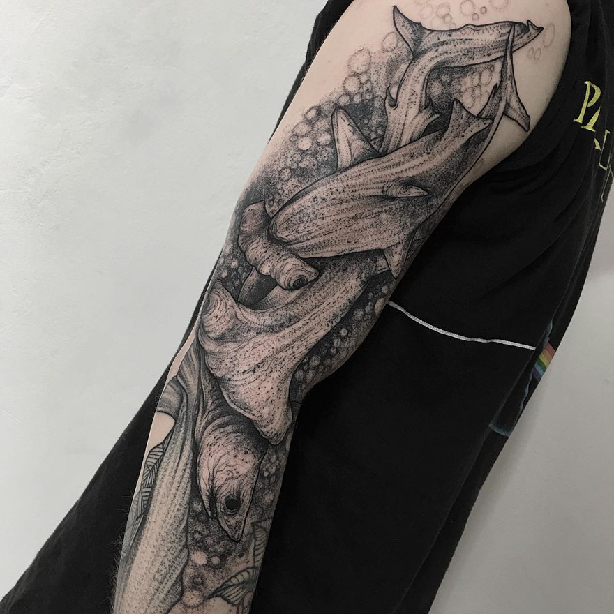 Arm featuring an intricate creature tattoo by a Russian artist, showcasing a dark and eerie design.