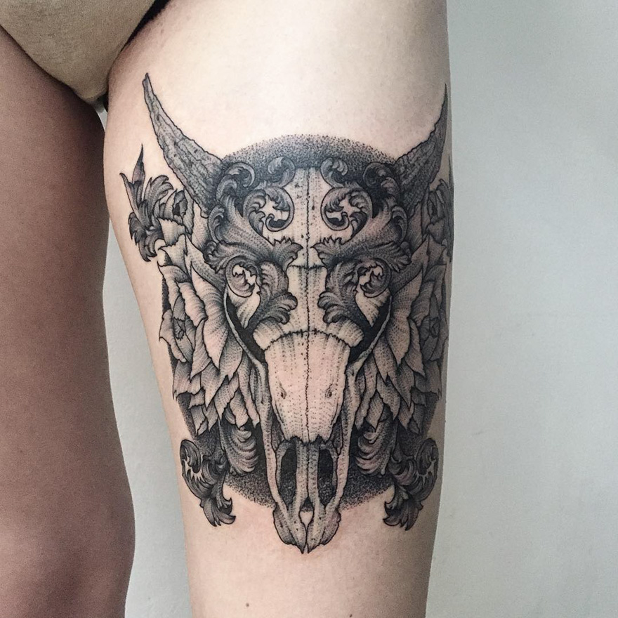 Dark and eerie creature tattoo on thigh by Russian artist, featuring intricate designs and horned details.