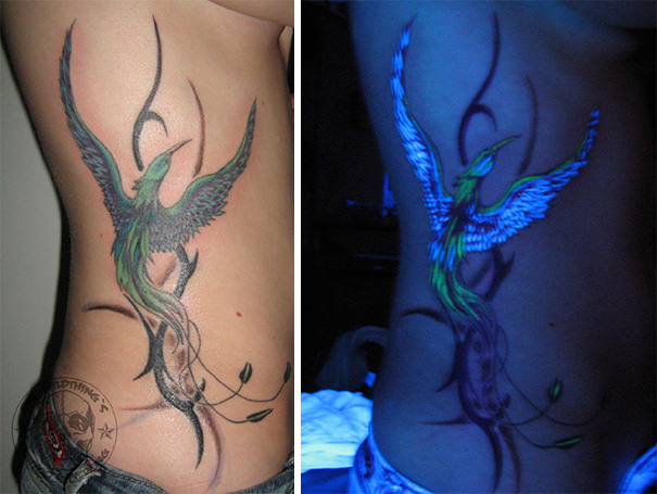 Glow in the dark tattoo of a bird on a side, visible under black light.