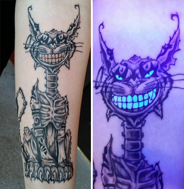 Glow in the dark tattoo of a grinning cat, visible under black light.