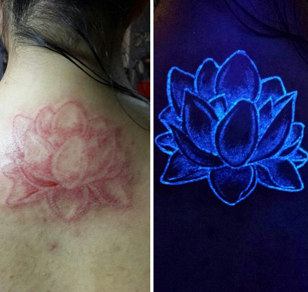 Glow in the dark lotus tattoo on skin, visible under black light.