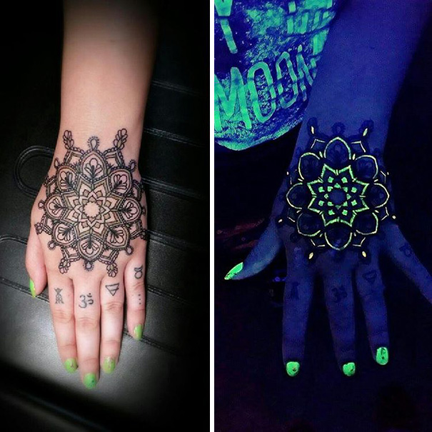 Glow in the dark tattoos on hands, visible under black light.
