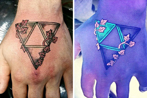 Hand tattoo with geometric design and leaves, glowing under black light with vibrant colors.