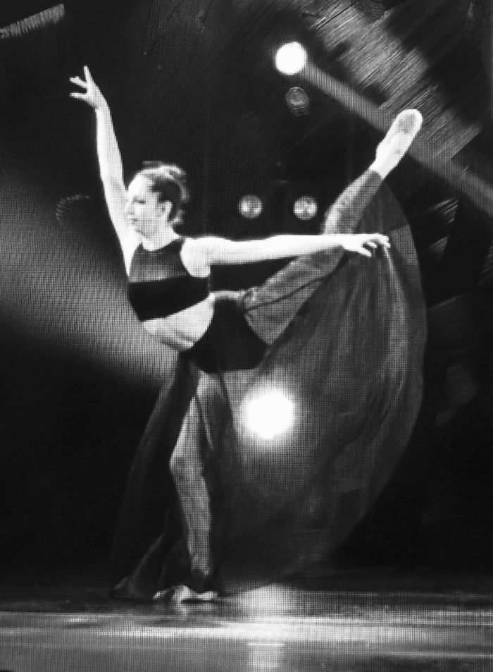 Ballet dancer in a dramatic pose on stage, celebrating Ballet Day with grace and elegance.