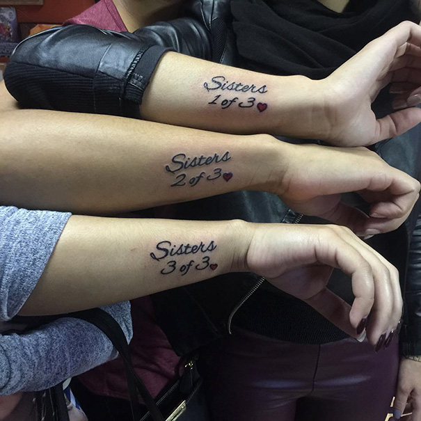 Three arms with matching sister tattoos reading "Sisters 1 of 3", "2 of 3", and "3 of 3".