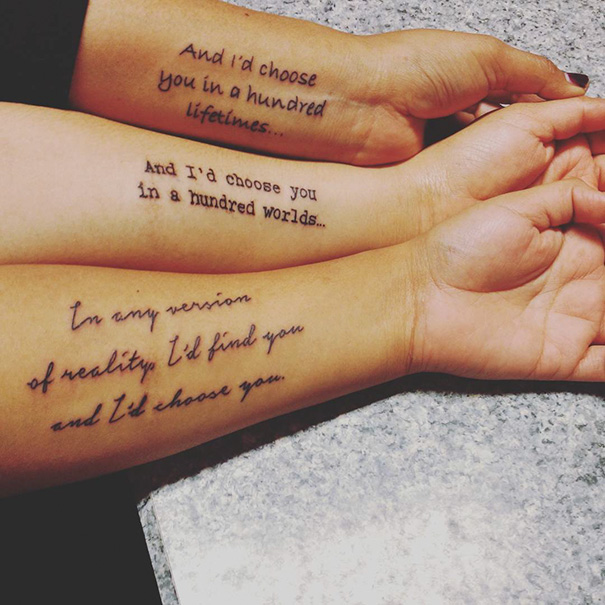 Sister tattoos on forearms with matching quotes about choosing each other in every reality.
