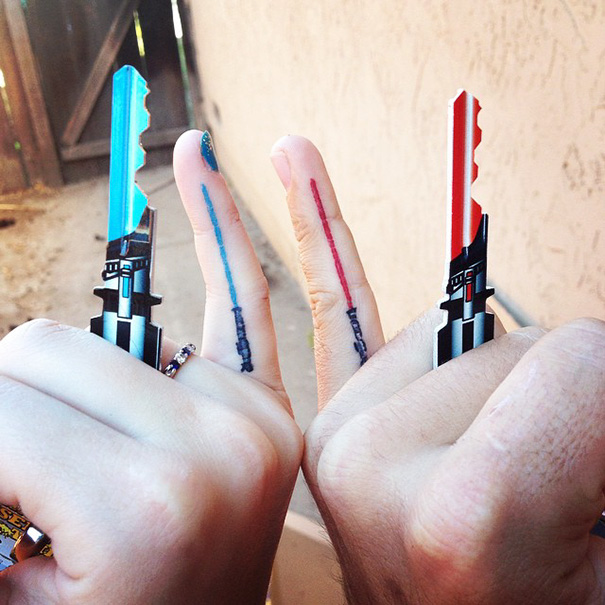 Two fingers with lightsaber tattoos, showing a sister bond.