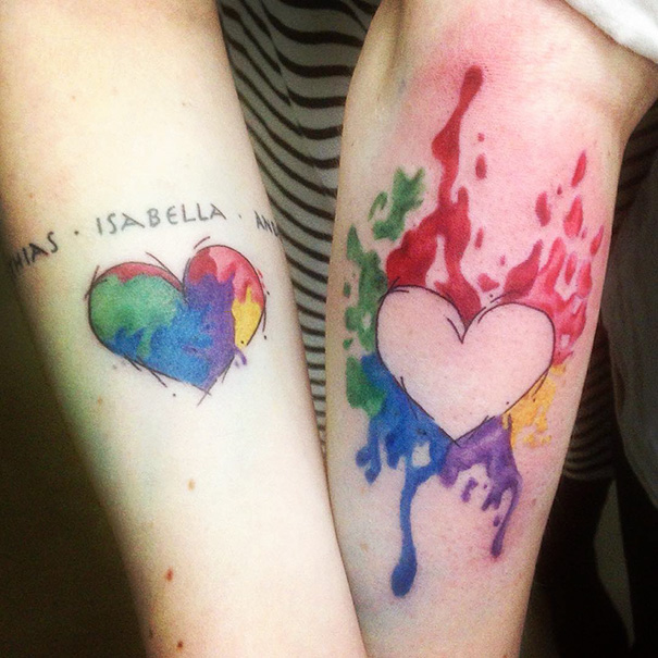 Colorful heart tattoos on sisters' arms, symbolizing their bond.