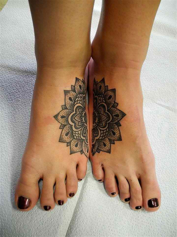 Mandala sister tattoos on feet, black intricate design symbolizing bond and unity.