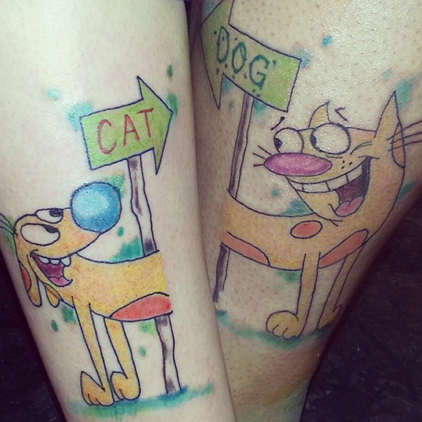 CatDog sister tattoos on legs, featuring colorful cartoon characters, symbolizing a strong sisterly bond.
