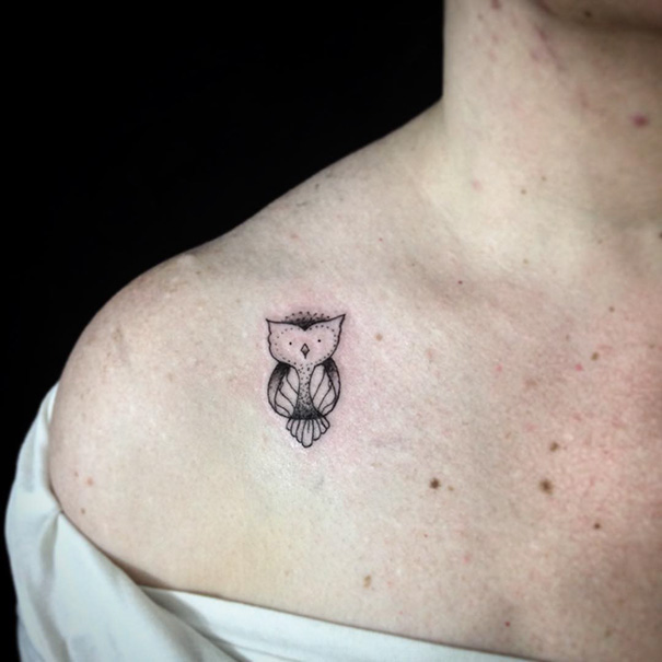 Minimalist owl tattoo on shoulder, showcasing simple ink design.