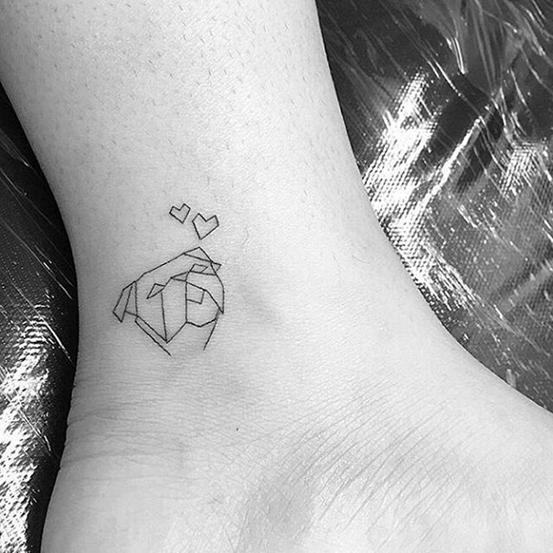 Minimalist tattoo of an origami rose with hearts on an ankle.