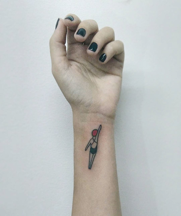Minimalist tattoo of a diver on a wrist, featuring simple lines and colors.