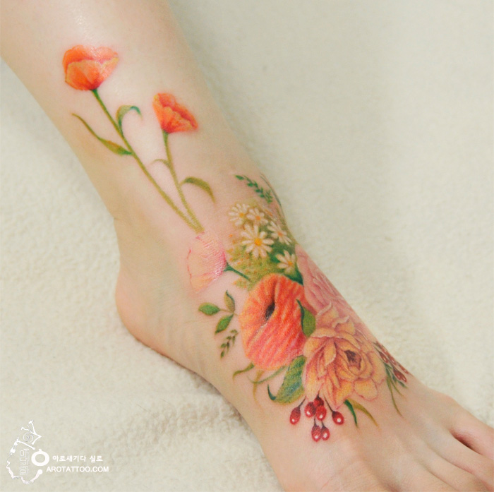 Watercolor flower tattoo on ankle, resembling a colorful painting. Watercolor flower tattoo on ankle, resembling a colorful painting.
