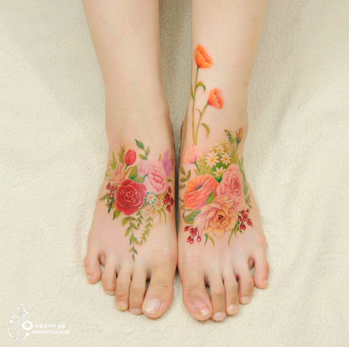 Watercolor flower tattoos on feet, resembling delicate paintings on skin. Watercolor flower tattoos on feet, resembling delicate paintings on skin.