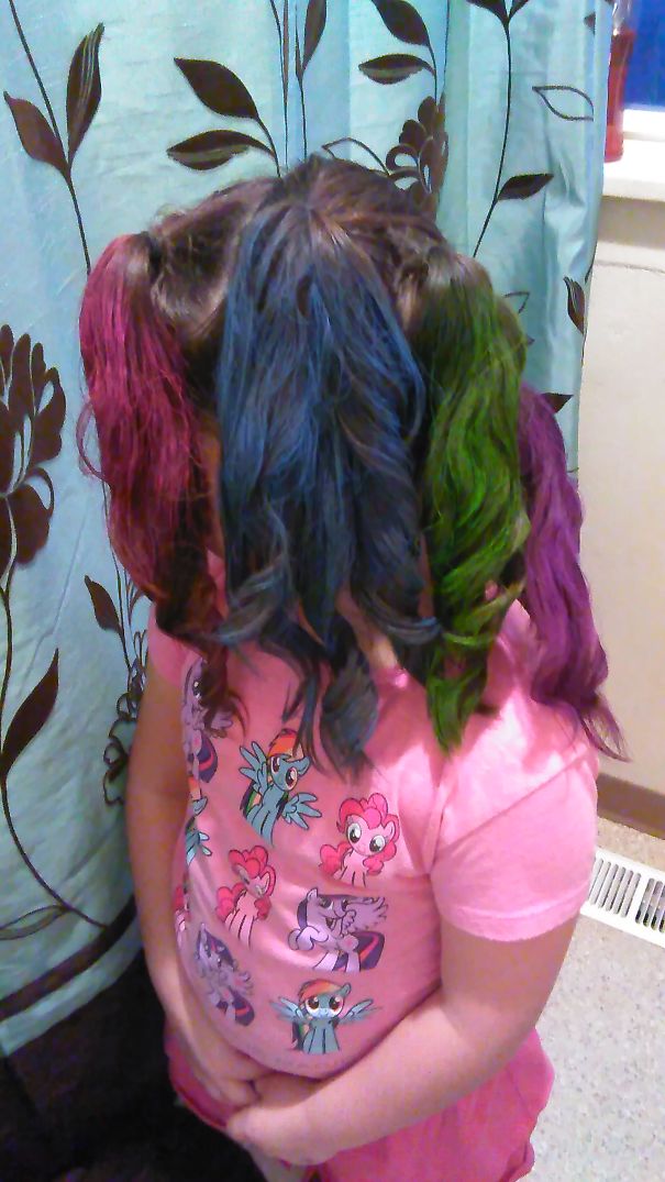 Child with vibrant, multicolored hairstyle for Crazy Hair Day, wearing a pink My Little Pony shirt.