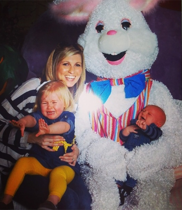 Woman with two distressed children next to a vintage Easter bunny costume.