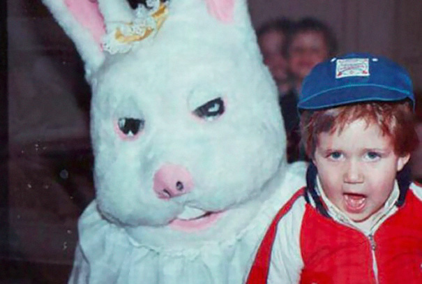 Child with a vintage Easter Bunny costume, featuring eerie eyes and crooked smile, capturing a nightmarish vibe.