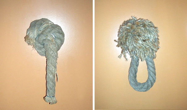 Funny bathroom signs featuring ropes humorously shaped like male and female symbols on a beige wall.