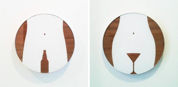 Funny bathroom signs depicting a bottle and a glass on round plaques.