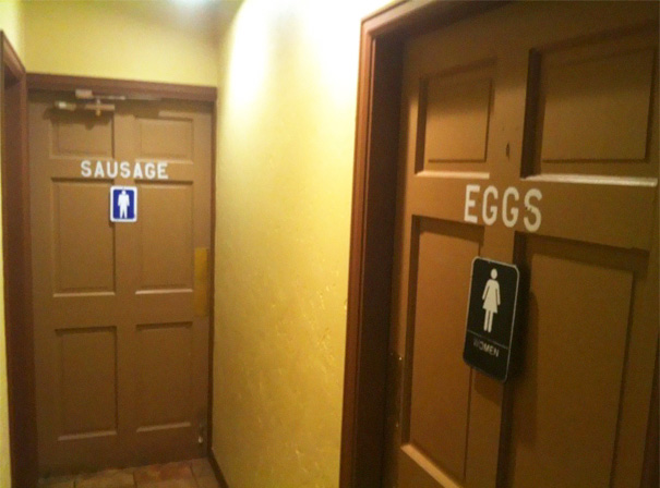 Funny bathroom signs for men labeled "sausage" and women labeled "eggs."