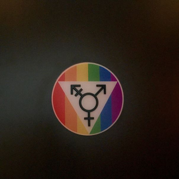 Transgender bathroom sign with rainbow background, found internationally.