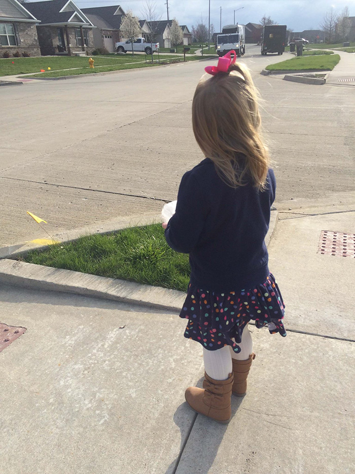 Sad girl looking at the truck driving away Sad girl looking at the truck driving away