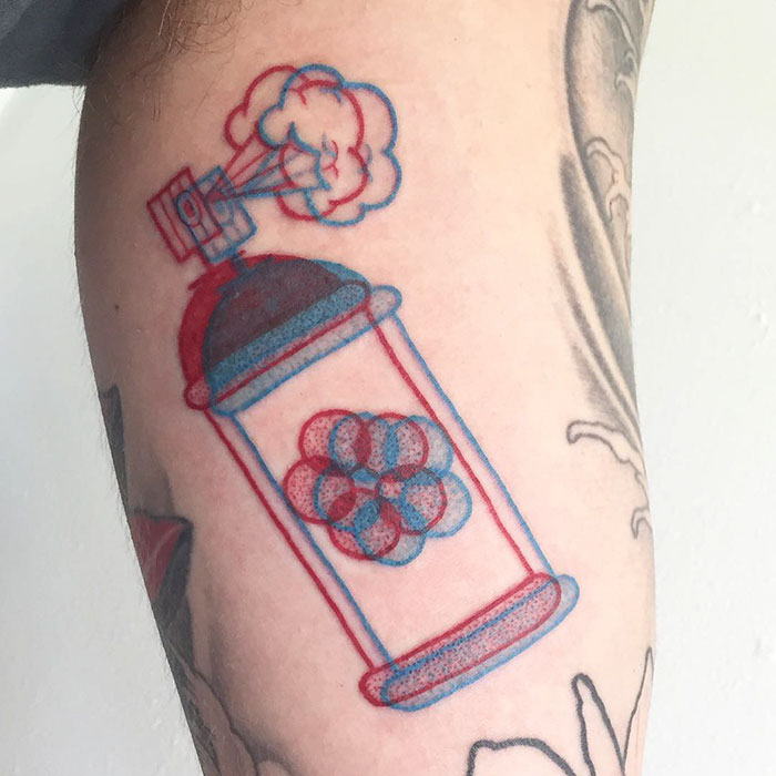 3D-inspired tattoo of a red and blue spray can with a cloud emitting from nozzle, showcasing modern ink art on skin.