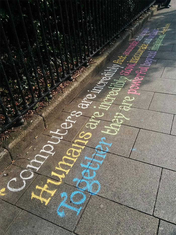 Colorful chalk handwriting on pavement, showcasing impressive lettering styles.