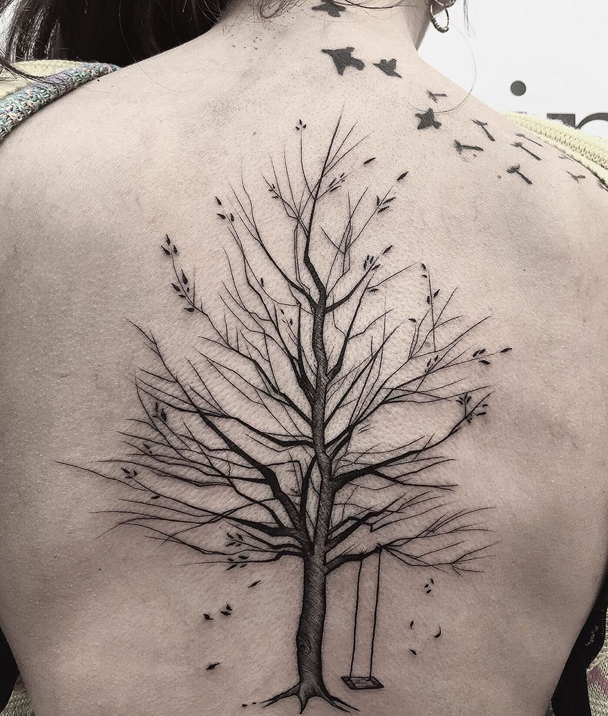 Sketch tattoo of a leafless tree with a swing on a person's back, showcasing beauty in imperfection by Frank Carrilho.