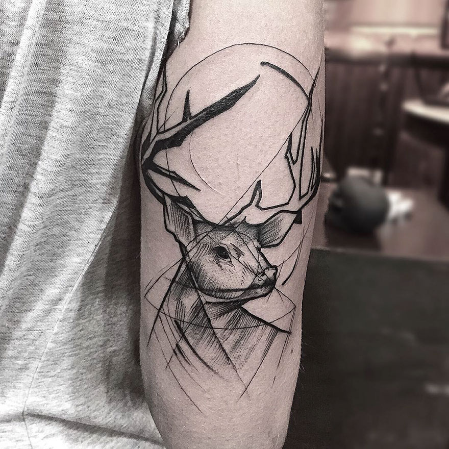 Sketch tattoo of a deer on an arm, showcasing the beauty of imperfection with bold lines and geometric shapes.