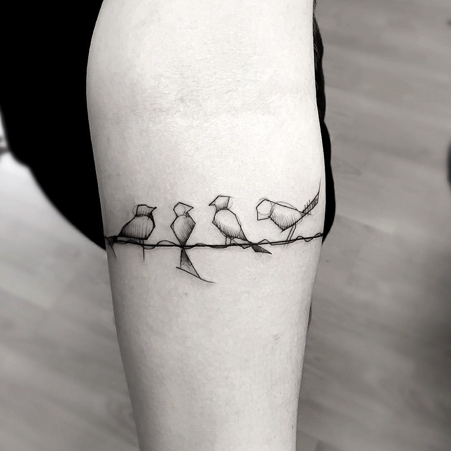Sketch tattoo on arm featuring abstract birds on a wire, highlighting beauty and imperfection.