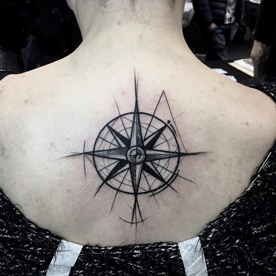 Compass sketch tattoo by Frank Carrilho on a person's upper back, showcasing the beauty of imperfection.