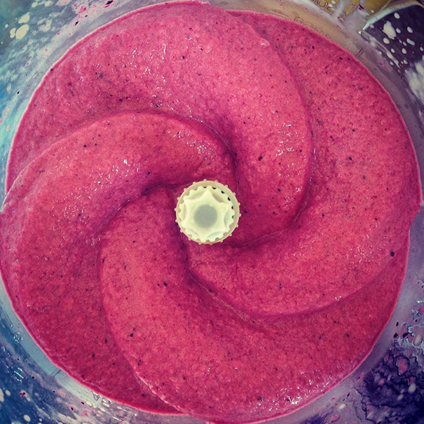 Perfectly blended pink smoothie swirl in a blender, satisfying every perfectionist's soul.