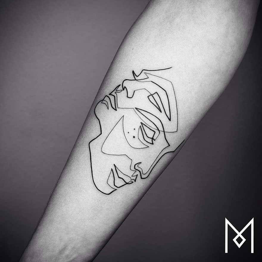 Minimalist single line tattoo on forearm, depicting an abstract face by Iranian-German artist.