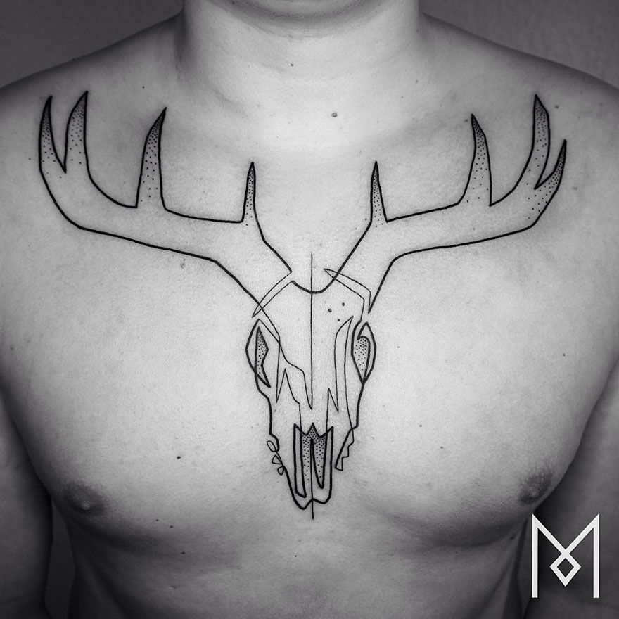 Minimalist single line tattoo of a deer skull on a man's chest, designed by an Iranian-German artist.