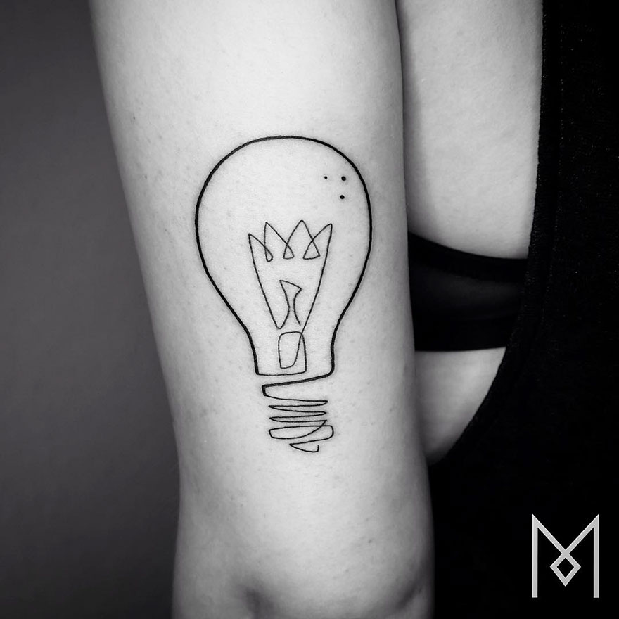Minimalist single line tattoo of a light bulb on an arm, by Iranian-German artist.