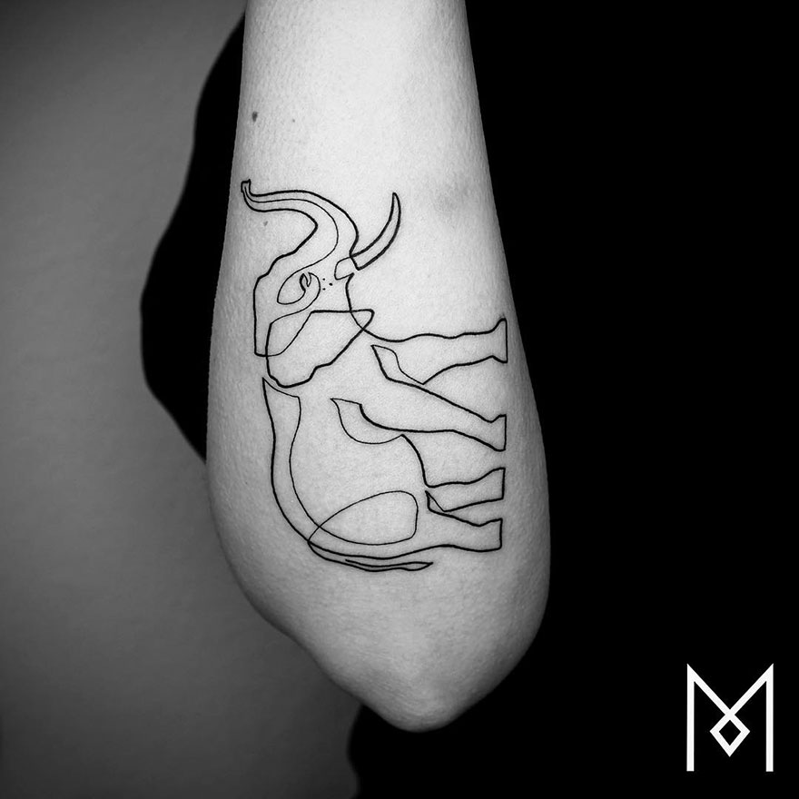 Minimalist single line tattoo of a bull on an arm by Iranian-German artist.