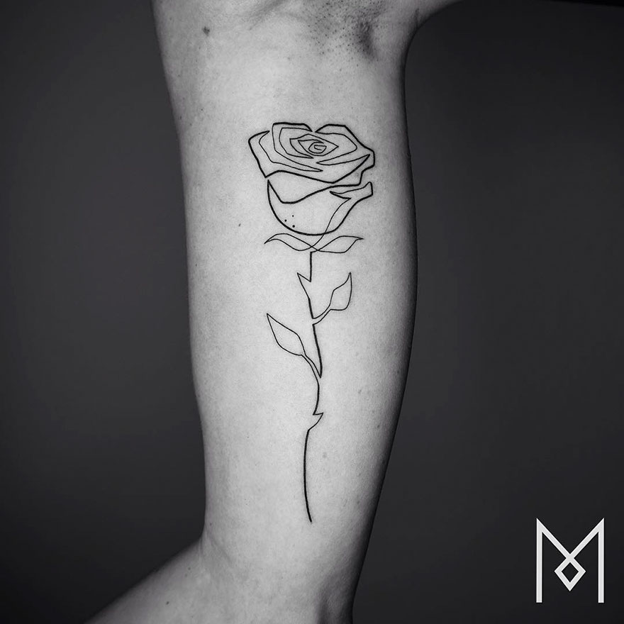 Minimalist single line tattoo of a rose on an arm by Iranian-German artist.