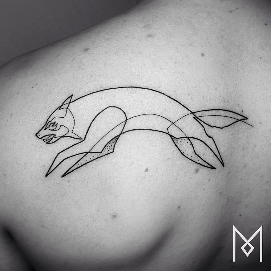 Minimalist single line tattoo of a wolf on a person's shoulder by Iranian-German artist.