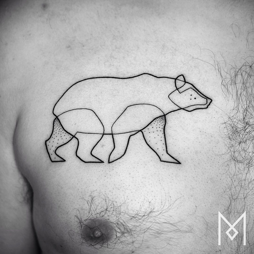 Minimalist single line tattoo of a bear on a person's chest, showcasing geometric design.