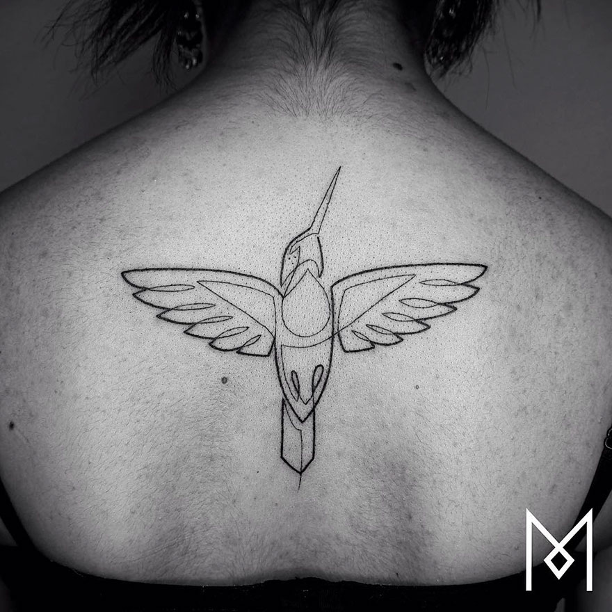 Minimalist single line hummingbird tattoo on a person's back by Iranian-German artist.