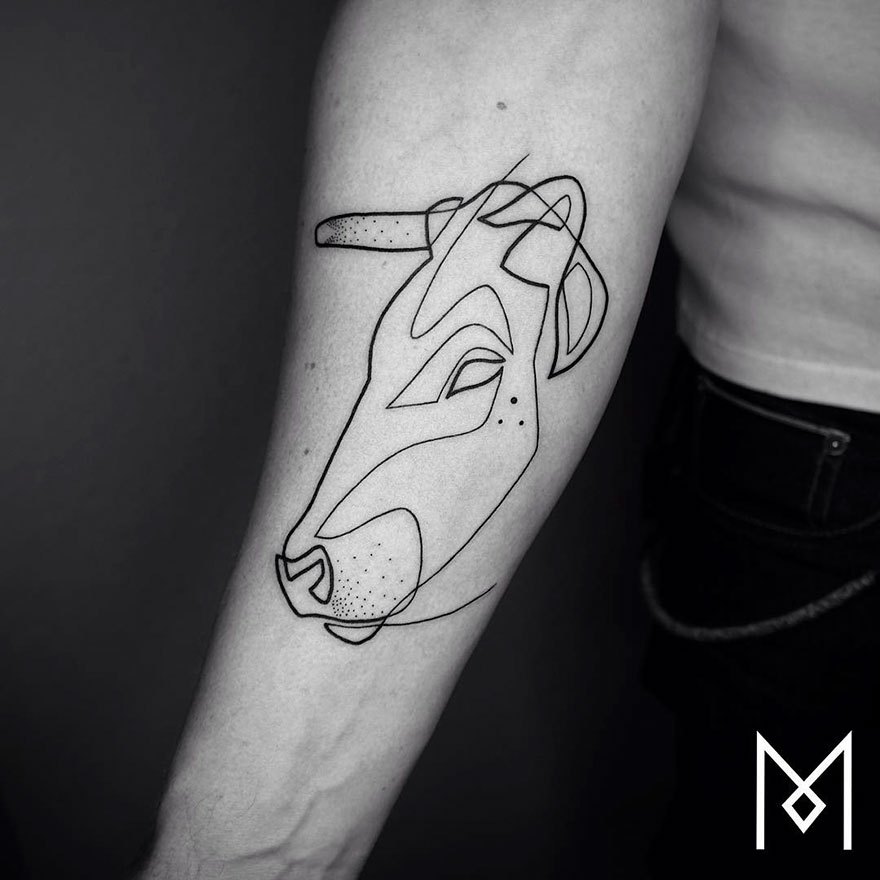 Minimalist single line tattoo of a bull on a person's forearm.