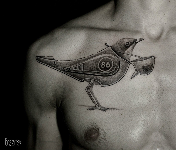 Surreal tattoos by Belarussian artist Ilya Brezinski featuring a mechanical bird design on a person's chest.