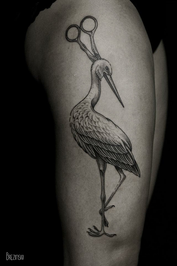 Surreal tattoo of a stork with scissor blades for a head by Belarussian artist Ilya Brezinski on a person's leg.