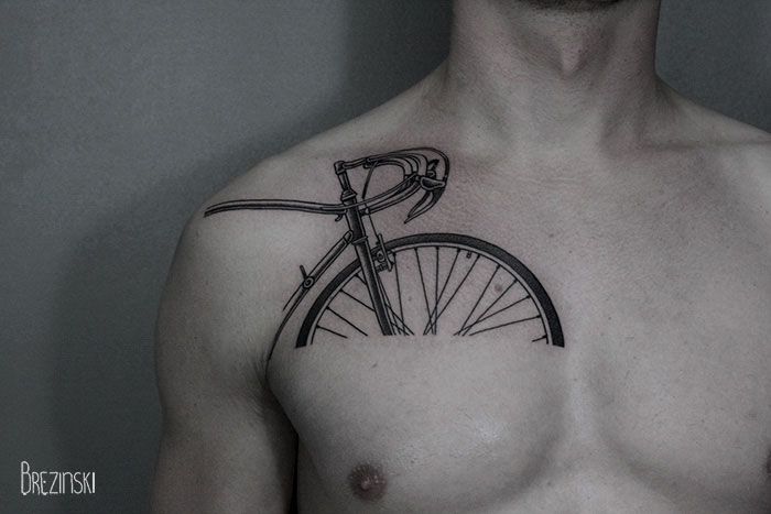 Surreal tattoo of a bicycle on a person's chest by a Belarussian artist.