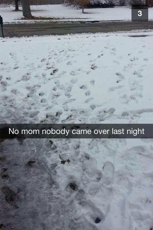 Snowy yard with footprints and humorous Snapchat caption.