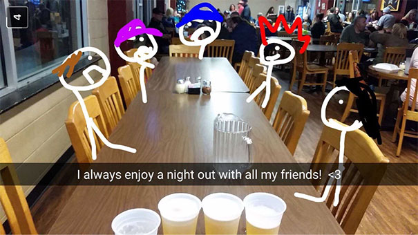 Funny Snapchat of an empty table with stick figures drawn as friends, captioned about enjoying a night out.